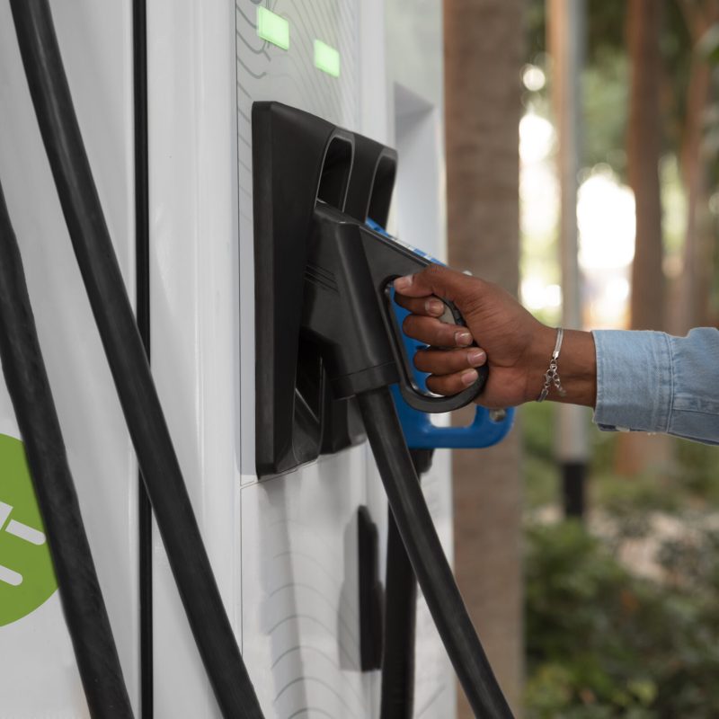 side-view-man-charging-electric-car